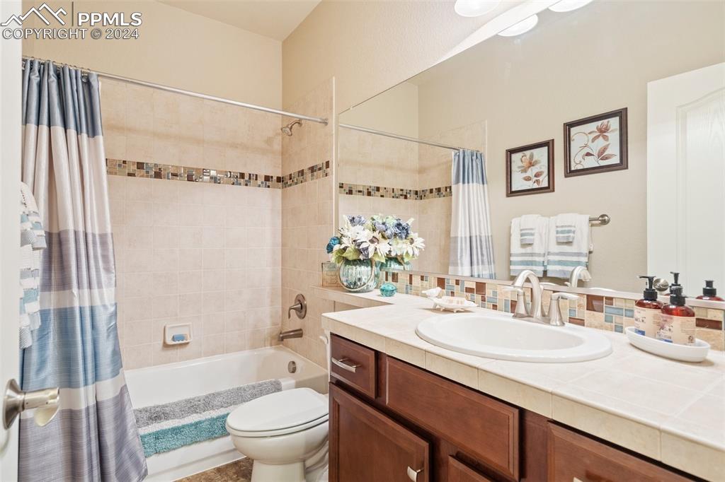 11501 Palmers Green Drive Peyton, CO 80831 - Photo 35 of 49 a bathroom with a sink a toilet and shower