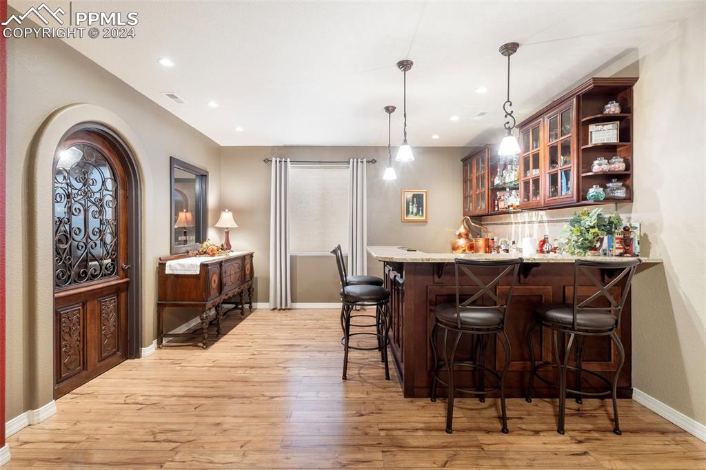 11501 Palmers Green Drive Peyton, CO 80831 - Photo 41 of 49 a dining hall with stainless steel appliances kitchen island a table and chairs