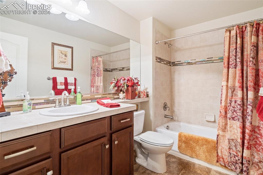 11501 Palmers Green Drive Peyton, CO 80831 - Photo 46 of 49 a bathroom with a sink mirror vanity and toilet