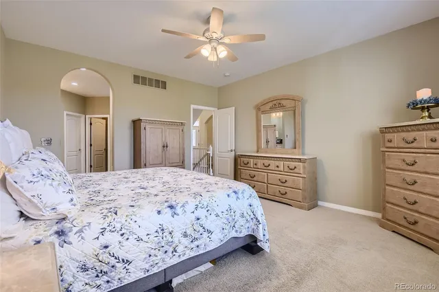 a bedroom with a bed a dresser and a mirror