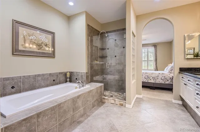 a spacious bathroom with a tub sink and shower