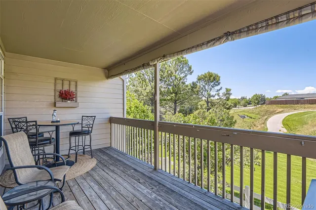 a view of a chairs and table in the balcony