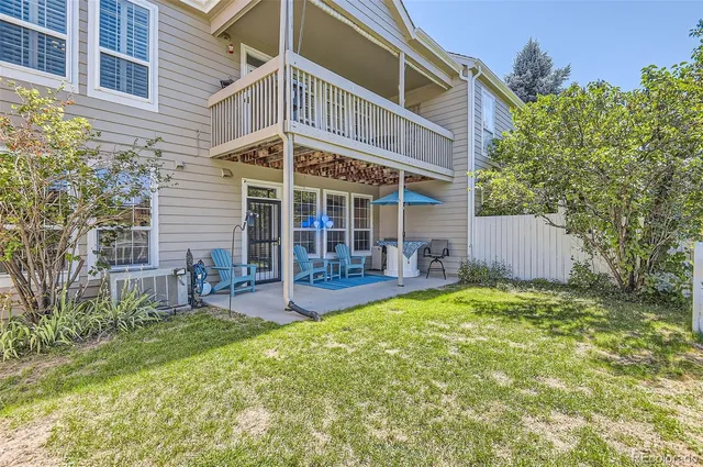 a view of a house with a yard patio and sitting area