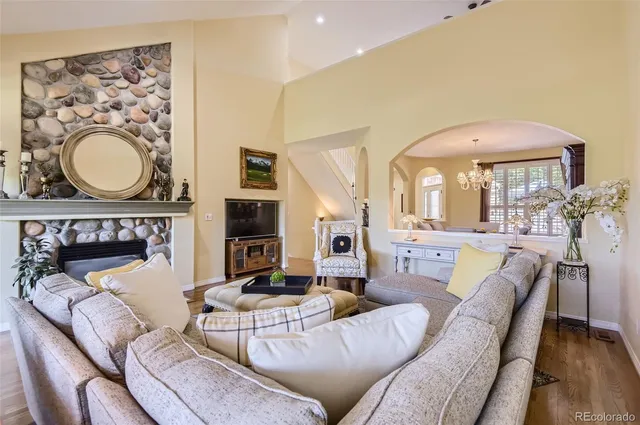 a living room with furniture a fireplace and a flat screen tv