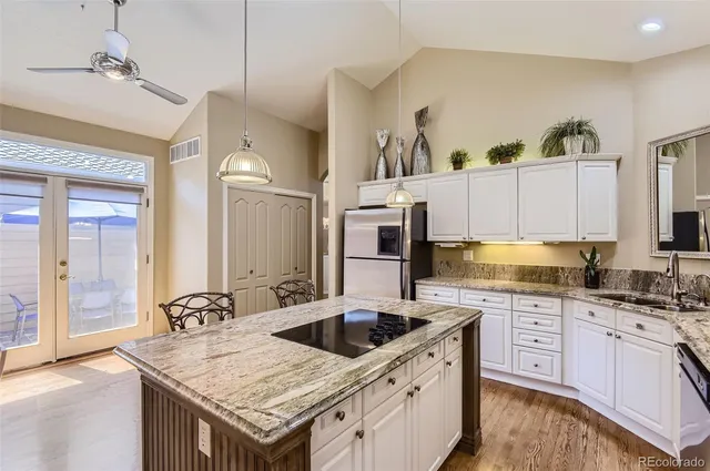 a kitchen with stainless steel appliances granite countertop a sink stove and cabinets