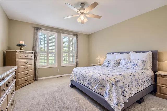 a bedroom with a bed a dresser and a window