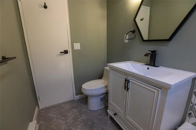 a bathroom with a sink toilet and mirror