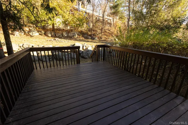 a balcony with wooden floor and trees