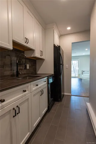 a kitchen with stainless steel appliances granite countertop a refrigerator and a stove