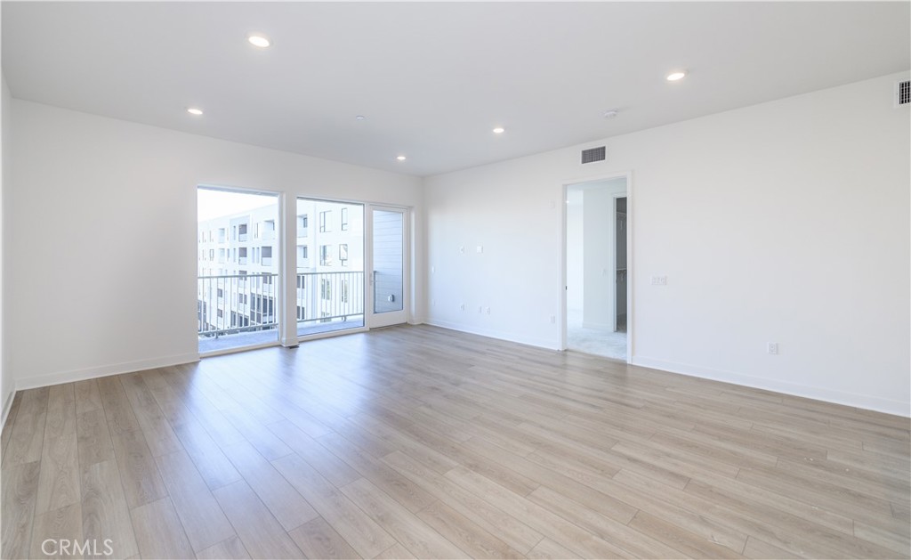 3608 Rivington Irvine, CA 92612 - Photo 11 of 53 a view of an empty room with wooden floor and a window