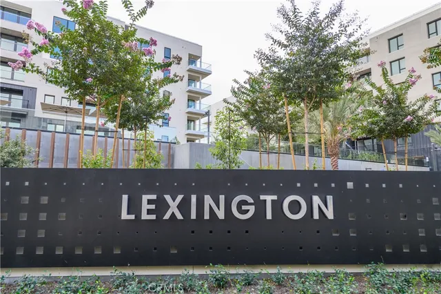 a kitchen with stainless steel appliances granite countertop a refrigerator a sink and a stove