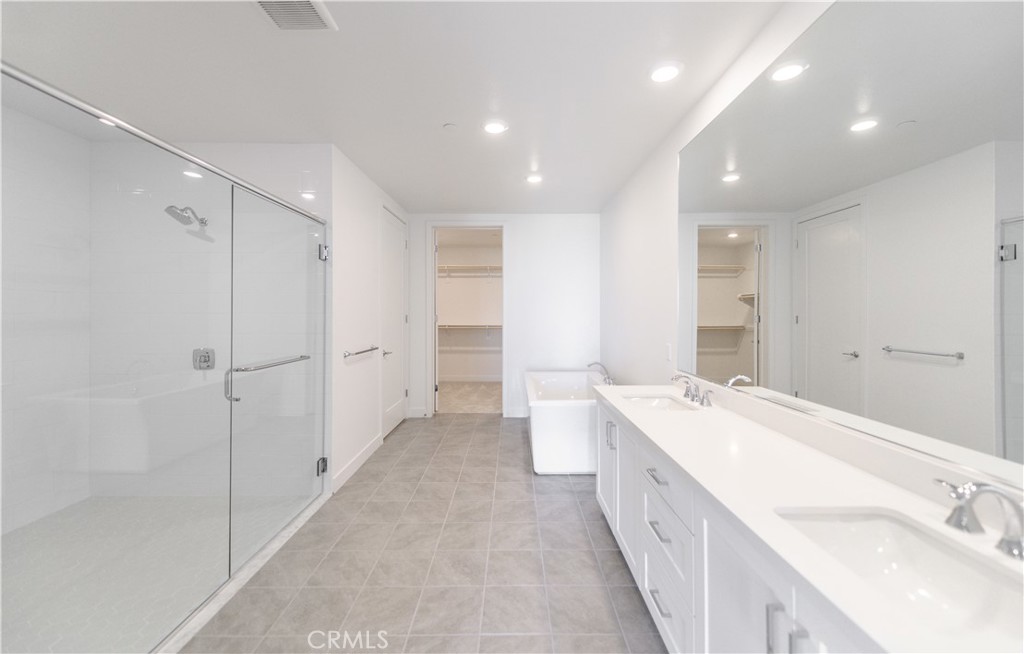 3608 Rivington Irvine, CA 92612 - Photo 25 of 53 a large bathroom with a double vanity sink and mirror