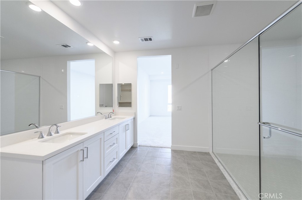 3608 Rivington Irvine, CA 92612 - Photo 28 of 53 a spacious bathroom with a double vanity sink and a mirror