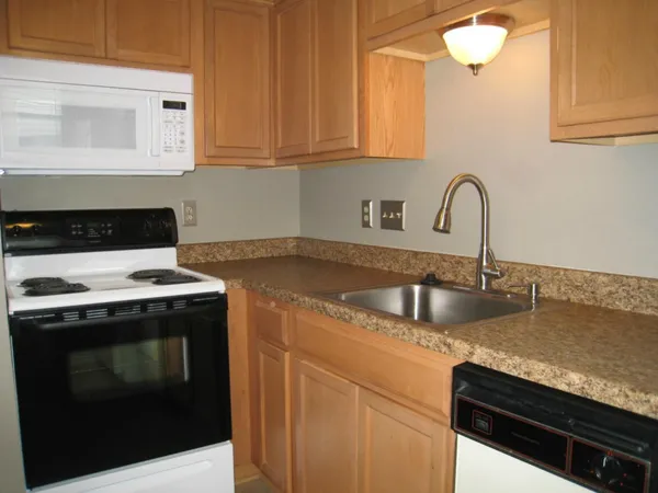 a kitchen with a stove and a sink