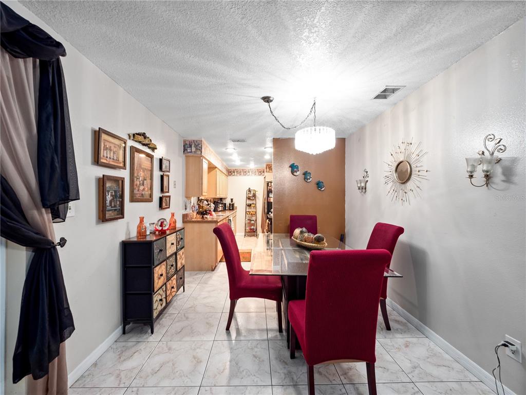 2810 Horton Road Kissimmee, FL 34744 - Photo 11 of 30 a view of a dining room with furniture and a chandelier