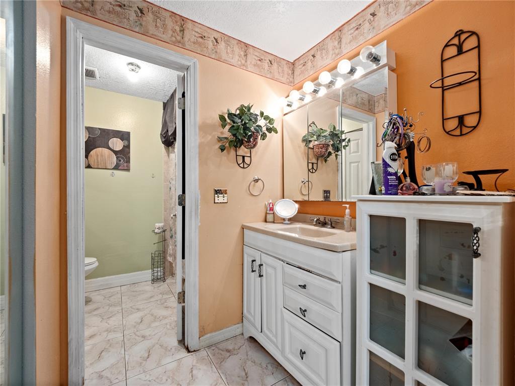 2810 Horton Road Kissimmee, FL 34744 - Photo 16 of 30 a bathroom with a double vanity sink and mirror