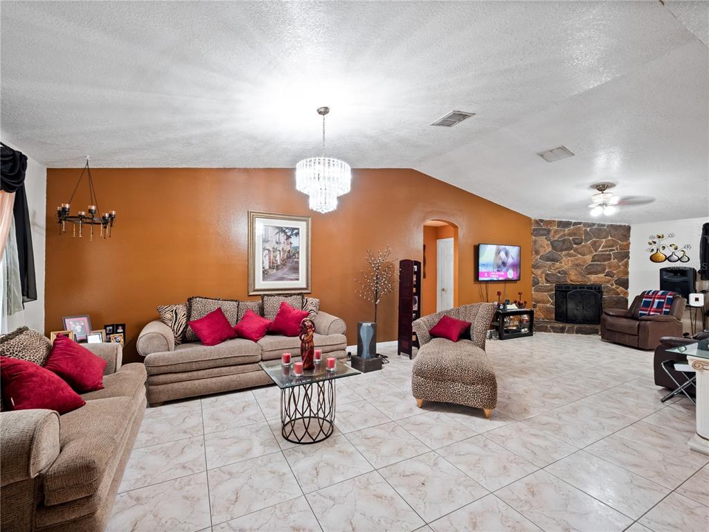 2810 Horton Road Kissimmee, FL 34744 - Photo 6 of 30 a living room with furniture and a fireplace