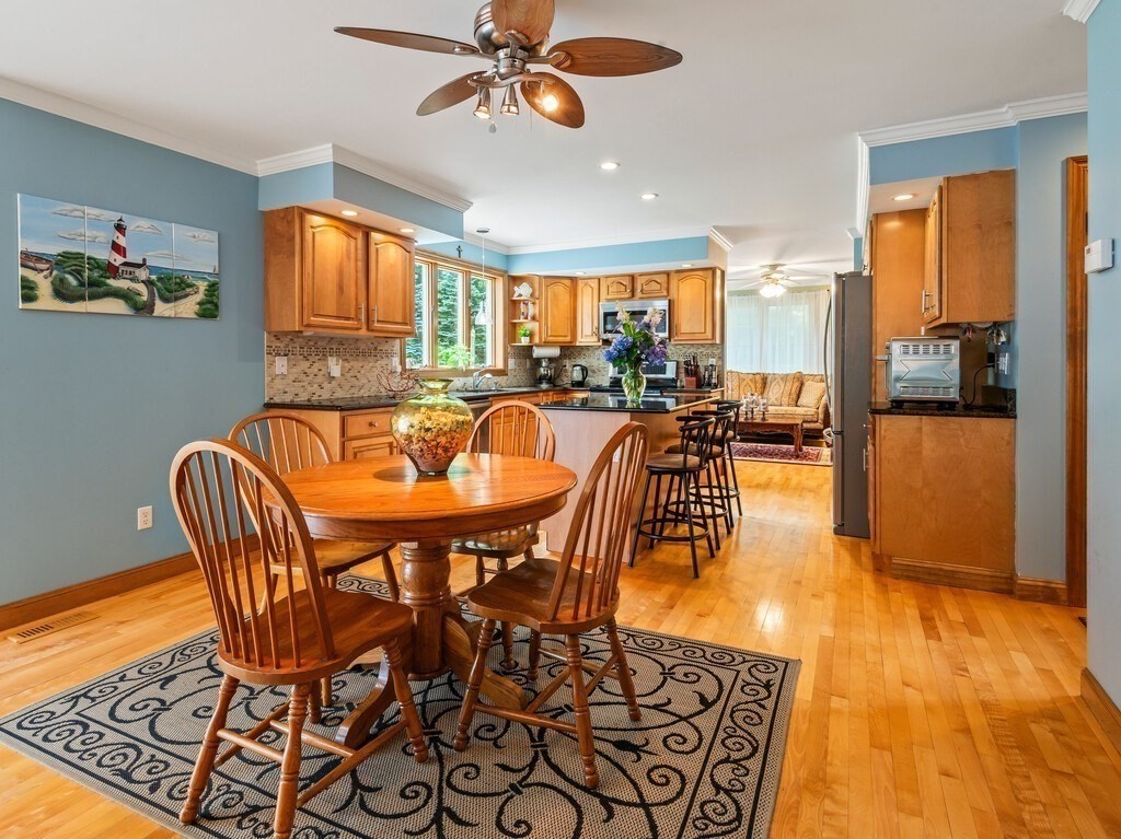 9 Santom Street Auburn, MA 01501 - Photo 8 of 42 a dining room with furniture a rug a potted plant and a chandelier