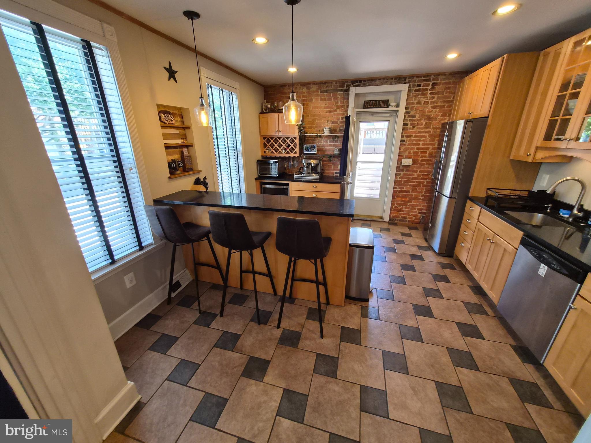 1601 Belt Street Baltimore, MD 21230 - Photo 8 of 30 a dining room with a black white checkered floor with chairs