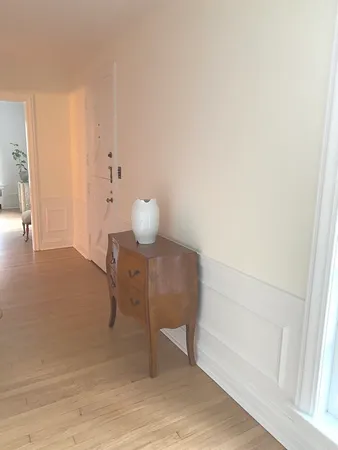 a view of an empty room and wooden floor