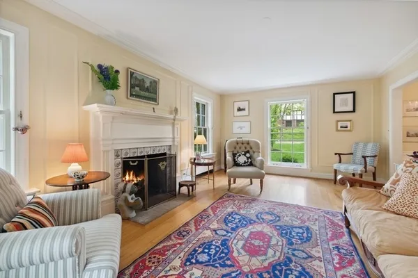 a living room with furniture fireplace and window