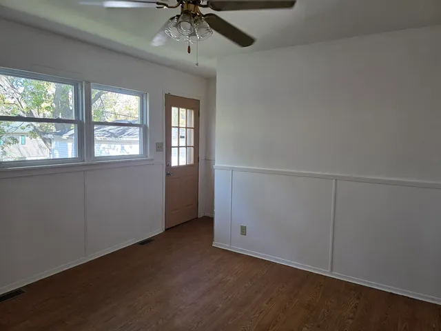 an empty room with a empty space and a ceiling fan
