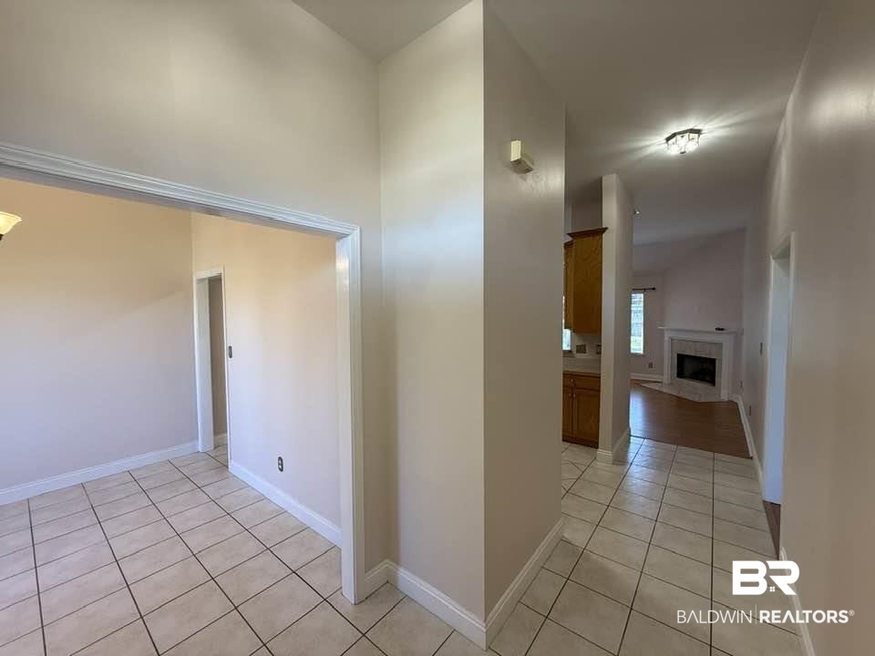 10428 South Side Loop Fairhope, AL 36532 - Photo 7 of 28 Hallway with light tile patterned floors and baseboards