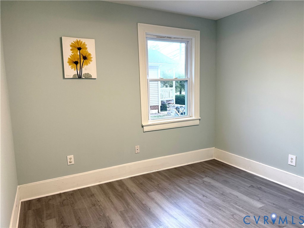 1748 Youngs Road Petersburg, VA 23803 - Photo 19 of 25 Spare room featuring baseboards and dark wood-styl