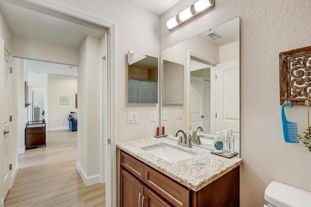 7314 Madrid Road Weeki Wachee, FL 34613 - Photo 26 of 54 a bathroom with a granite countertop sink and a mirror