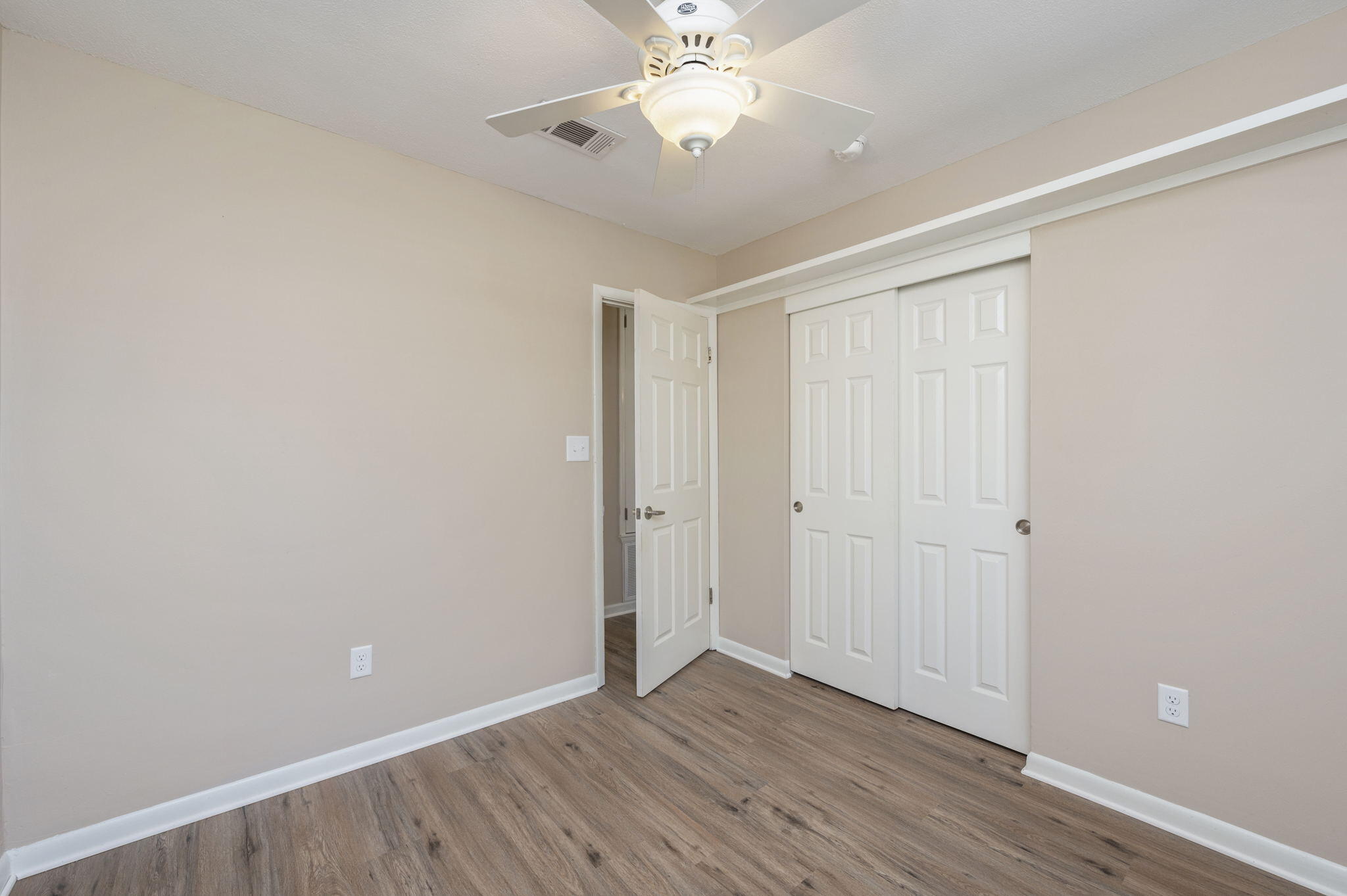 512 23rd Street Niceville, FL 32578 - Photo 11 of 19 a view of an empty room with wooden floor