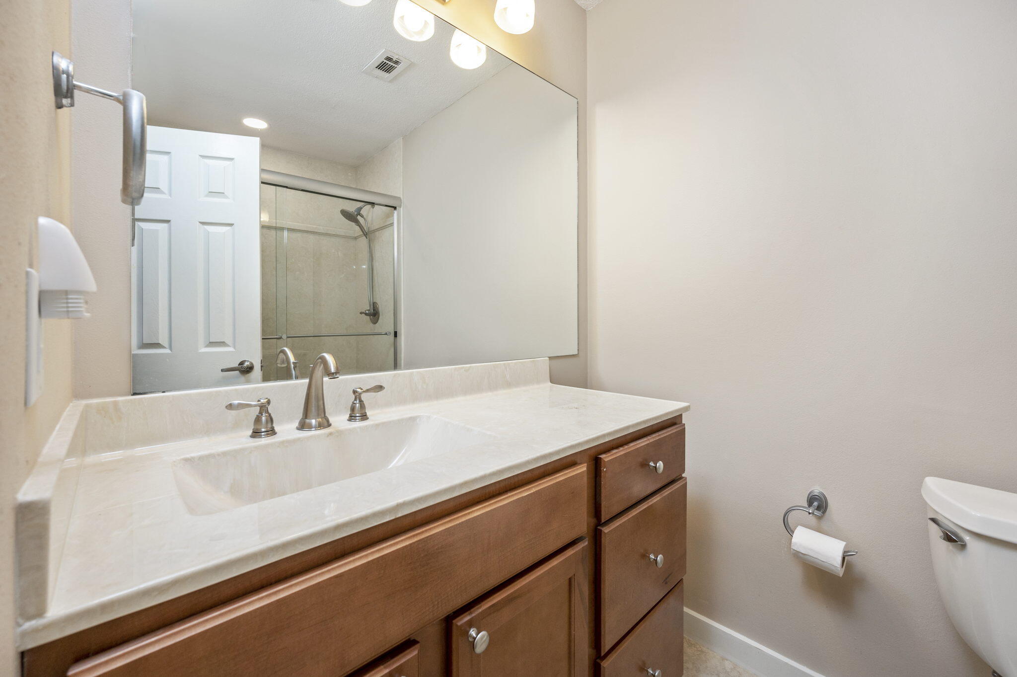 512 23rd Street Niceville, FL 32578 - Photo 12 of 19 a bathroom with a sink a toilet and a mirror