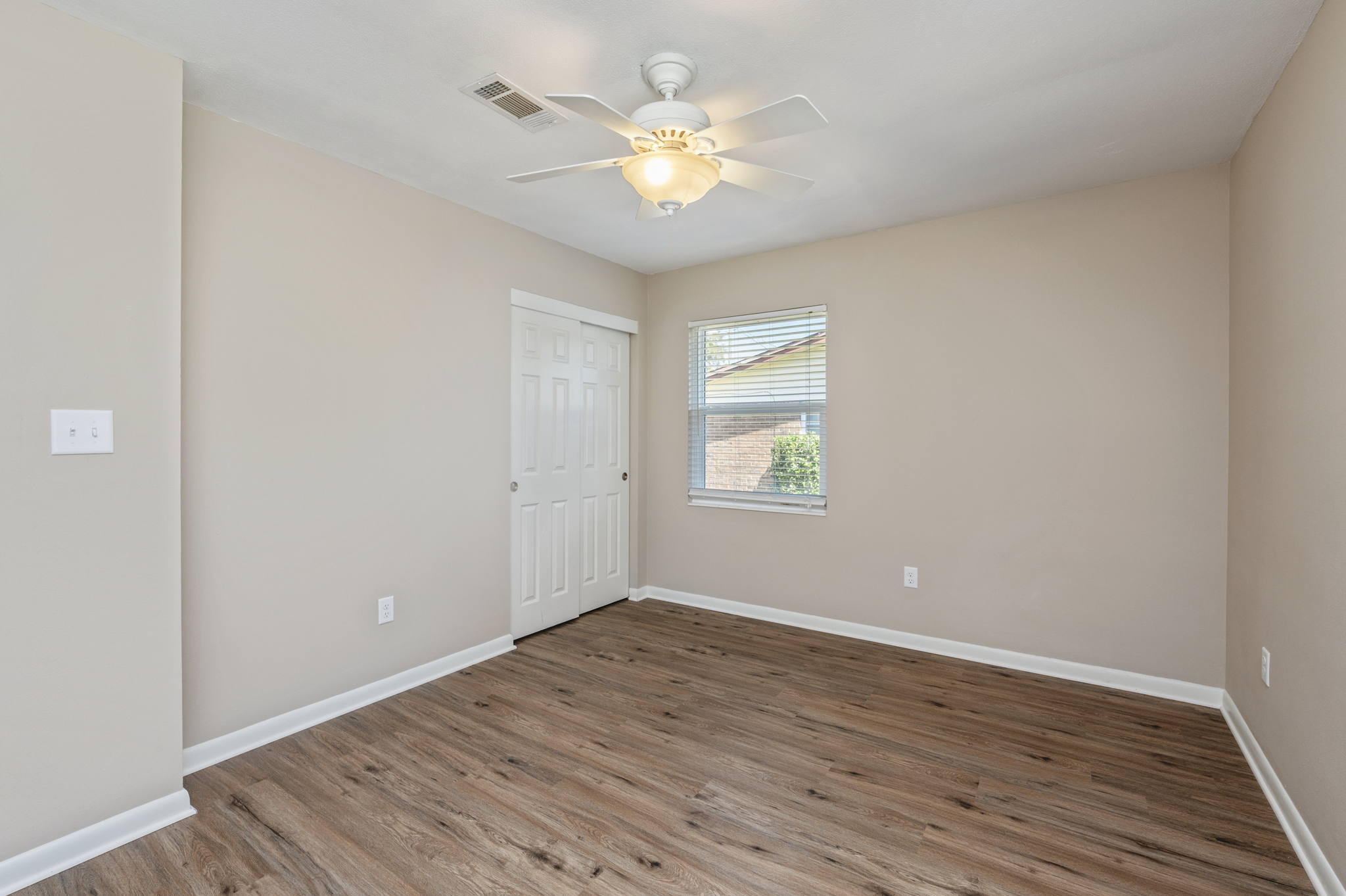512 23rd Street Niceville, FL 32578 - Photo 14 of 19 wooden floor in an empty room with a window