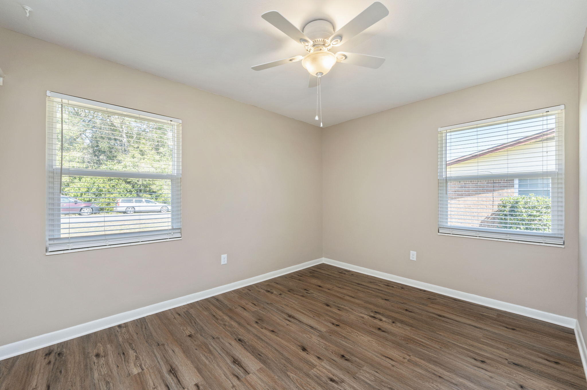 512 23rd Street Niceville, FL 32578 - Photo 15 of 19 a view of an empty room with wooden floor and a window