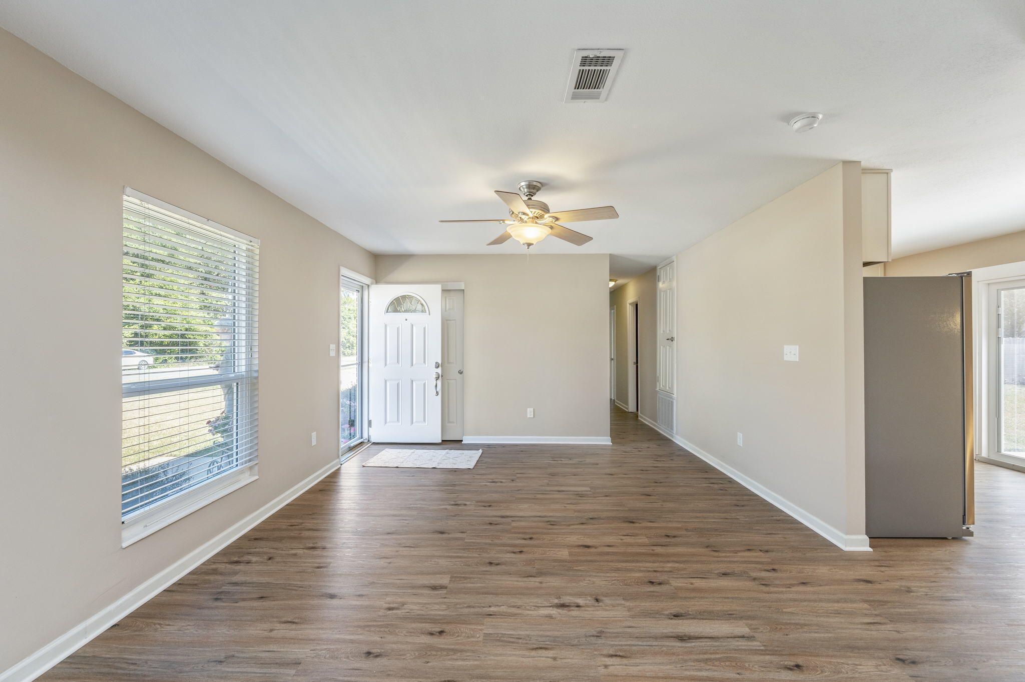 512 23rd Street Niceville, FL 32578 - Photo 5 of 19 a view of an empty room with wooden floor and a window