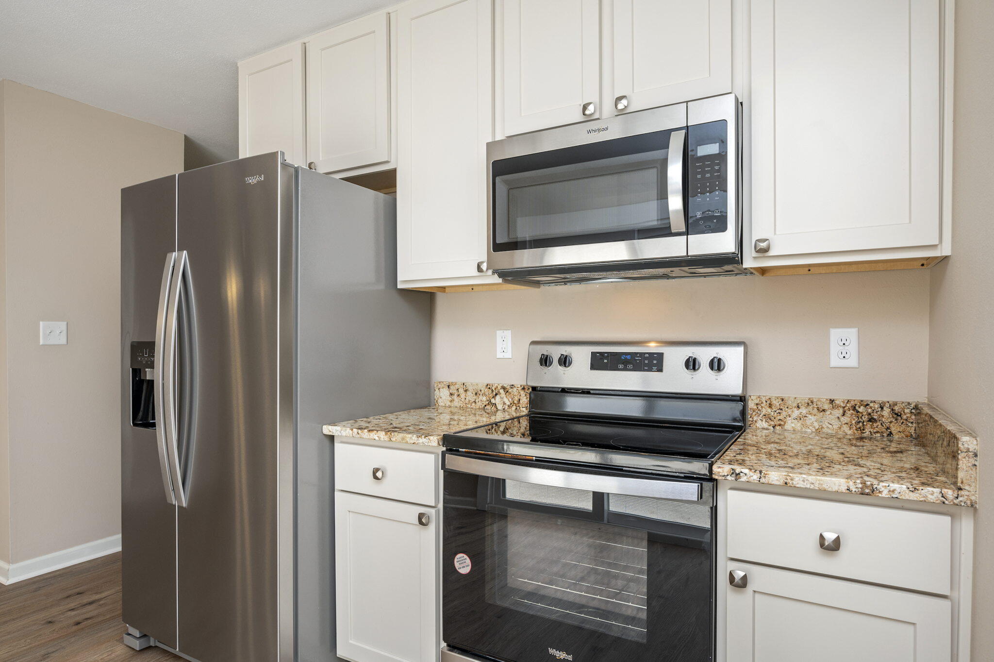 512 23rd Street Niceville, FL 32578 - Photo 7 of 19 a kitchen with stainless steel appliances granite countertop a refrigerator stove and microwave