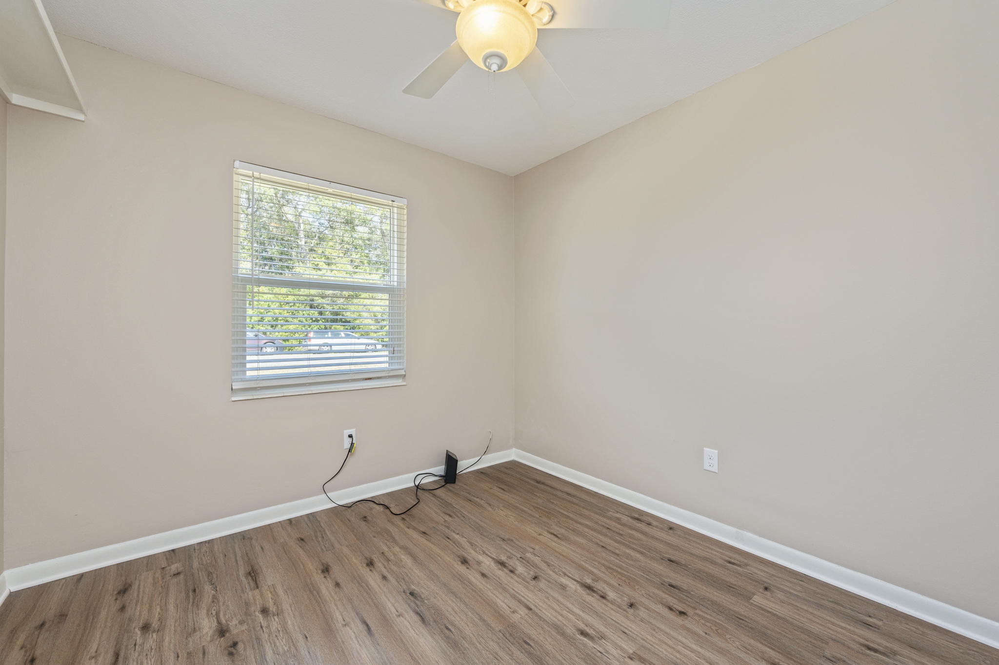512 23rd Street Niceville, FL 32578 - Photo 10 of 19 an empty room with wooden floor and windows