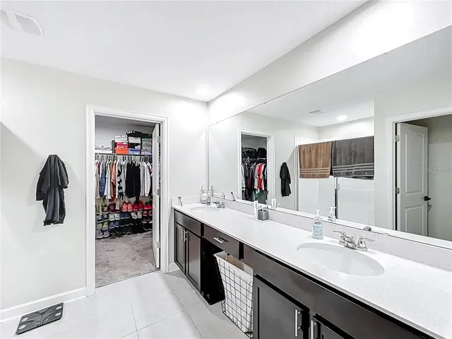 a bathroom with a double vanity sink and mirror