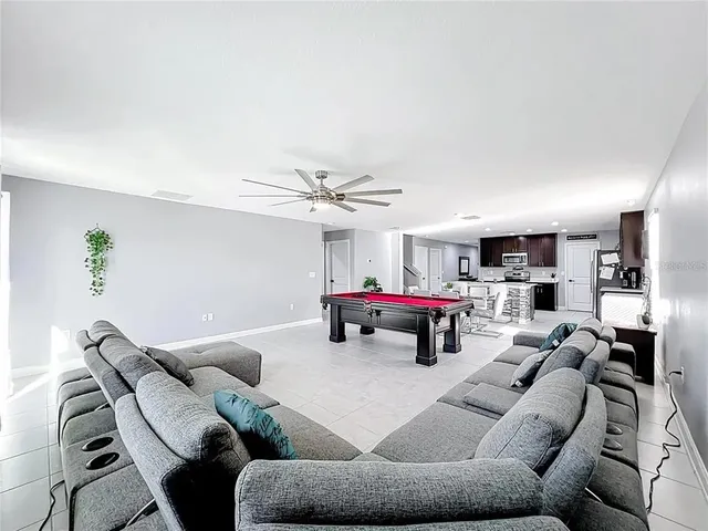 a living room with furniture and a chandelier
