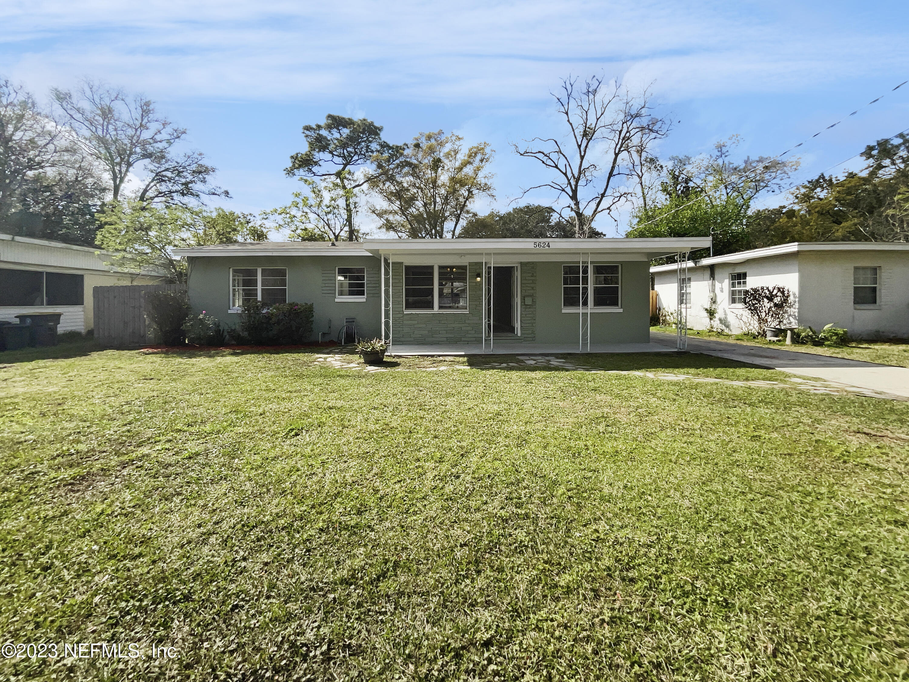 5624 Orangewood Road Jacksonville, FL 32207 - Photo 1 of 19 a front view of house with yard and trees in the background