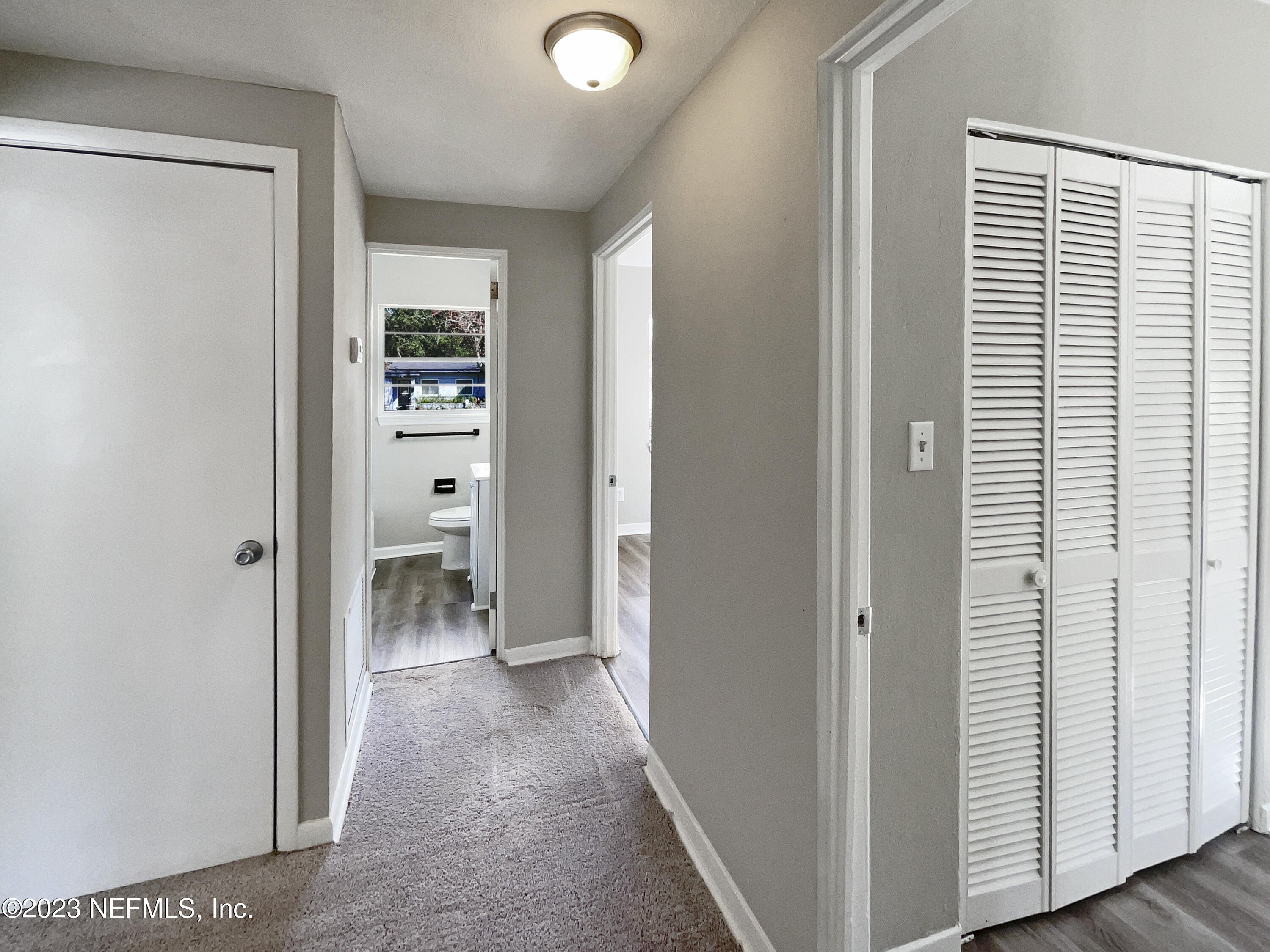 5624 Orangewood Road Jacksonville, FL 32207 - Photo 13 of 19 a view of a hallway with bathroom and wooden floor