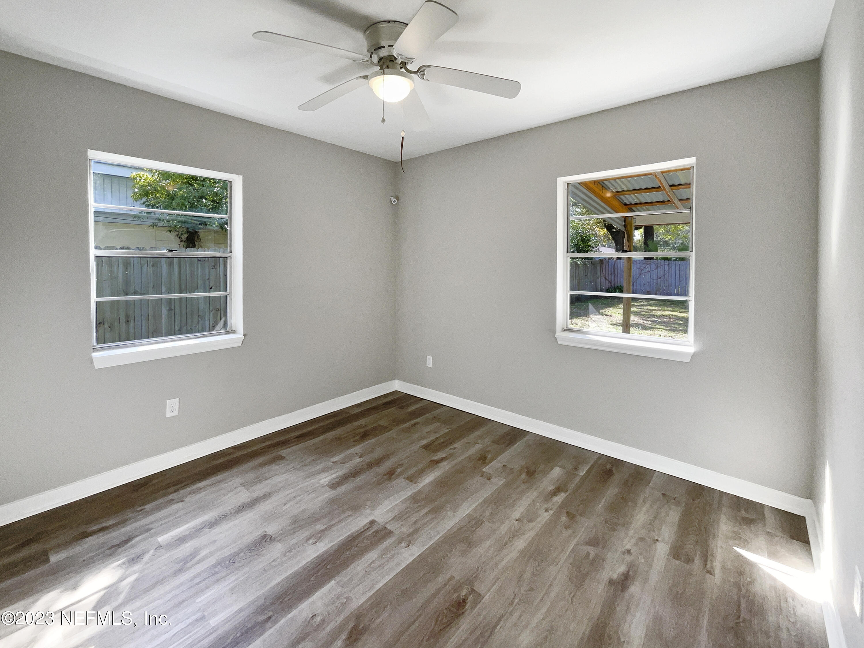 5624 Orangewood Road Jacksonville, FL 32207 - Photo 14 of 19 a view of an empty room with wooden floor and a window