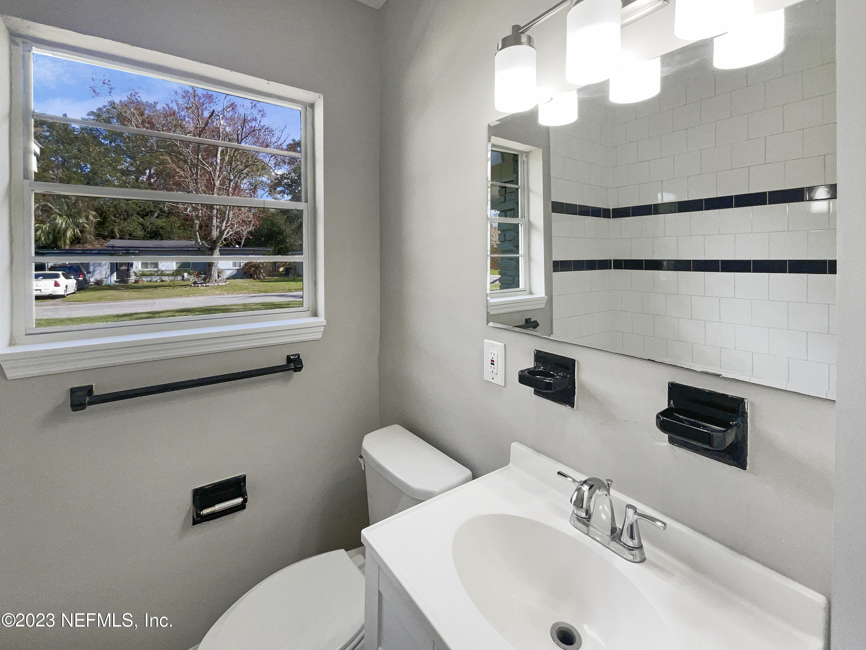 5624 Orangewood Road Jacksonville, FL 32207 - Photo 15 of 19 a bathroom with a sink and a mirror