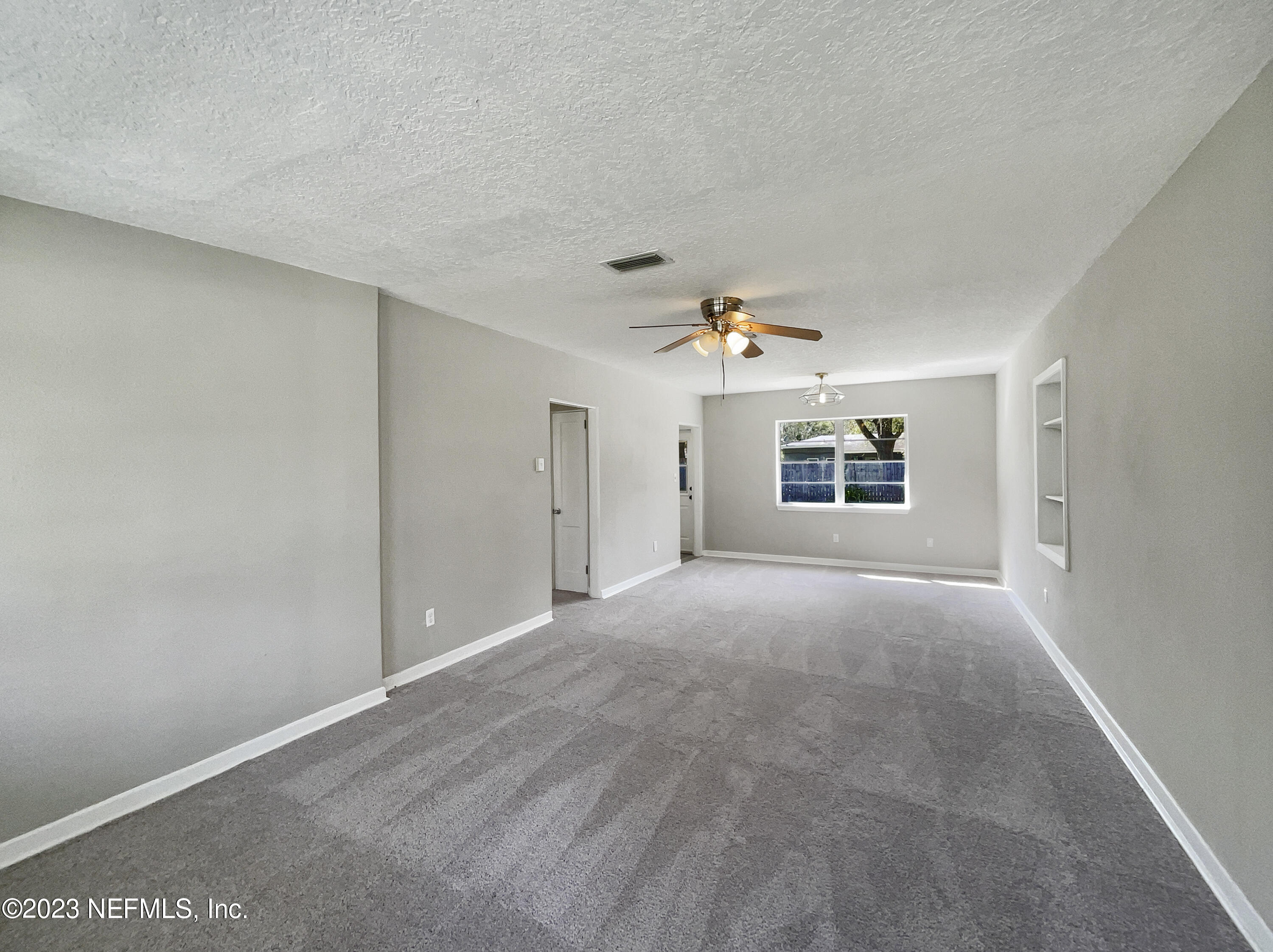 5624 Orangewood Road Jacksonville, FL 32207 - Photo 3 of 19 a view of a big room with windows and chandelier fan