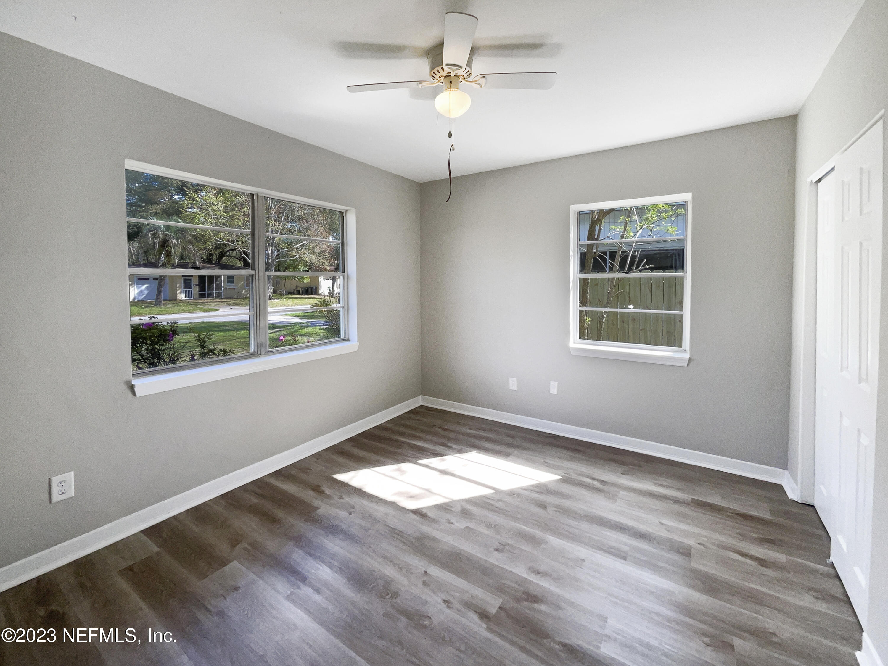 5624 Orangewood Road Jacksonville, FL 32207 - Photo 5 of 19 a view of an empty room with wooden floor and a window