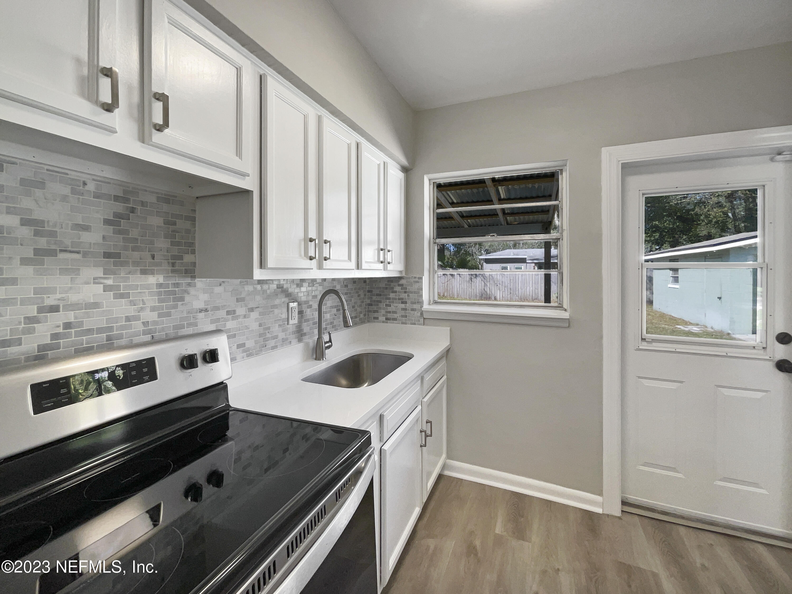 5624 Orangewood Road Jacksonville, FL 32207 - Photo 7 of 19 a kitchen with a stove and a sink