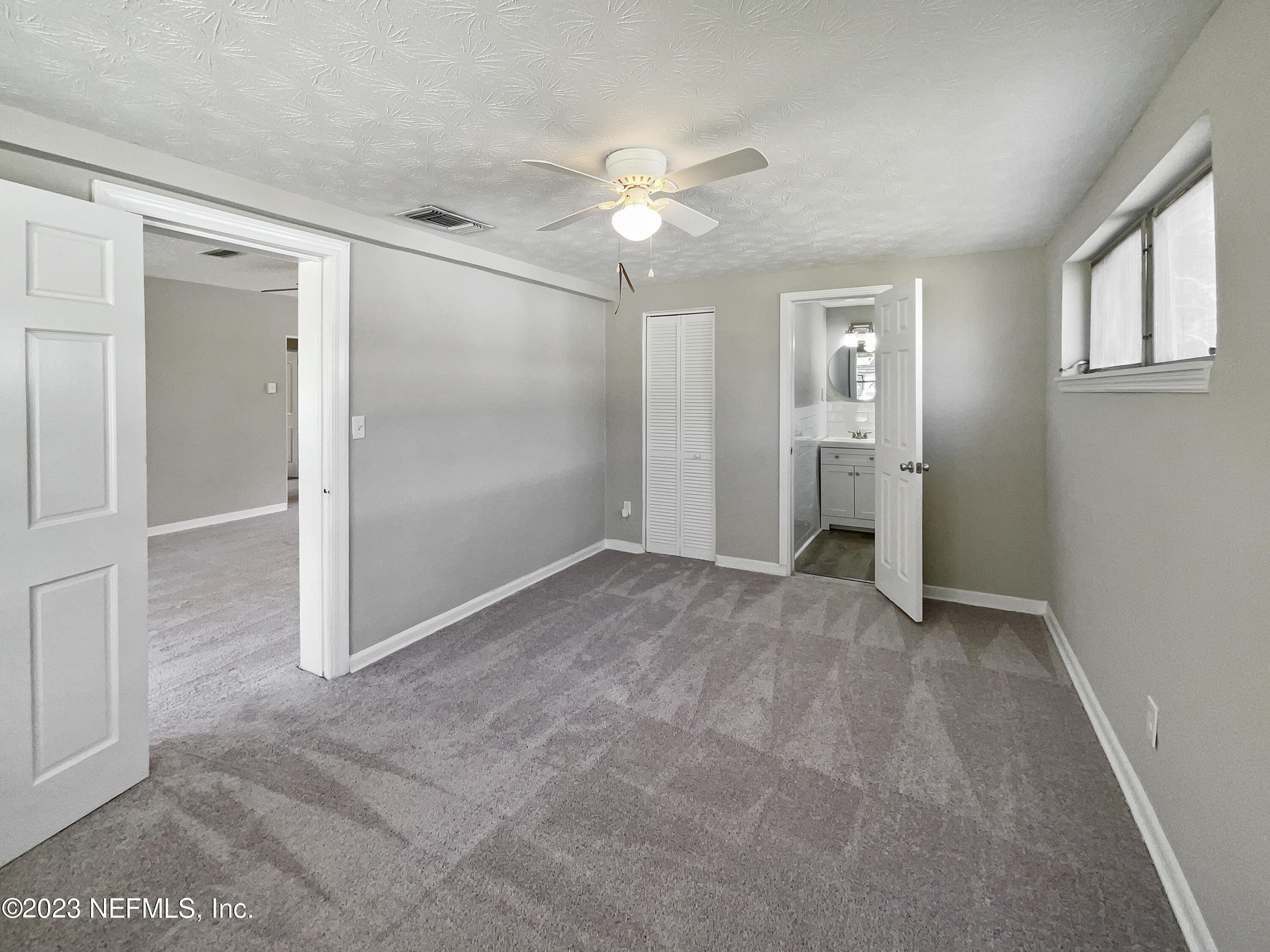 5624 Orangewood Road Jacksonville, FL 32207 - Photo 9 of 19 an empty space with closet and a ceiling fan