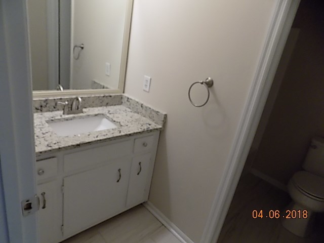 6340 Britt Road Macon, GA 31216 - Photo 14 of 21 a bathroom with a granite countertop sink and mirror