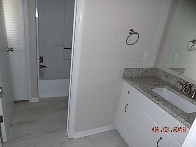 6340 Britt Road Macon, GA 31216 - Photo 19 of 21 a bathroom with a granite countertop sink and a mirror