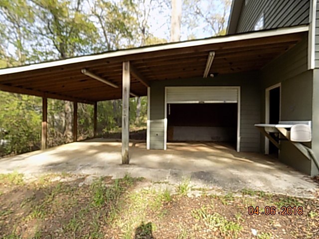 6340 Britt Road Macon, GA 31216 - Photo 4 of 21 a backyard of a house with yard and brick wall