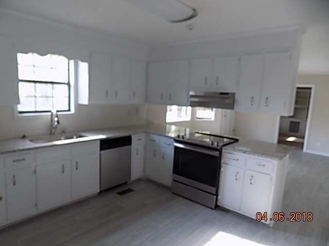6340 Britt Road Macon, GA 31216 - Photo 7 of 21 a kitchen with granite countertop white cabinets and white appliances
